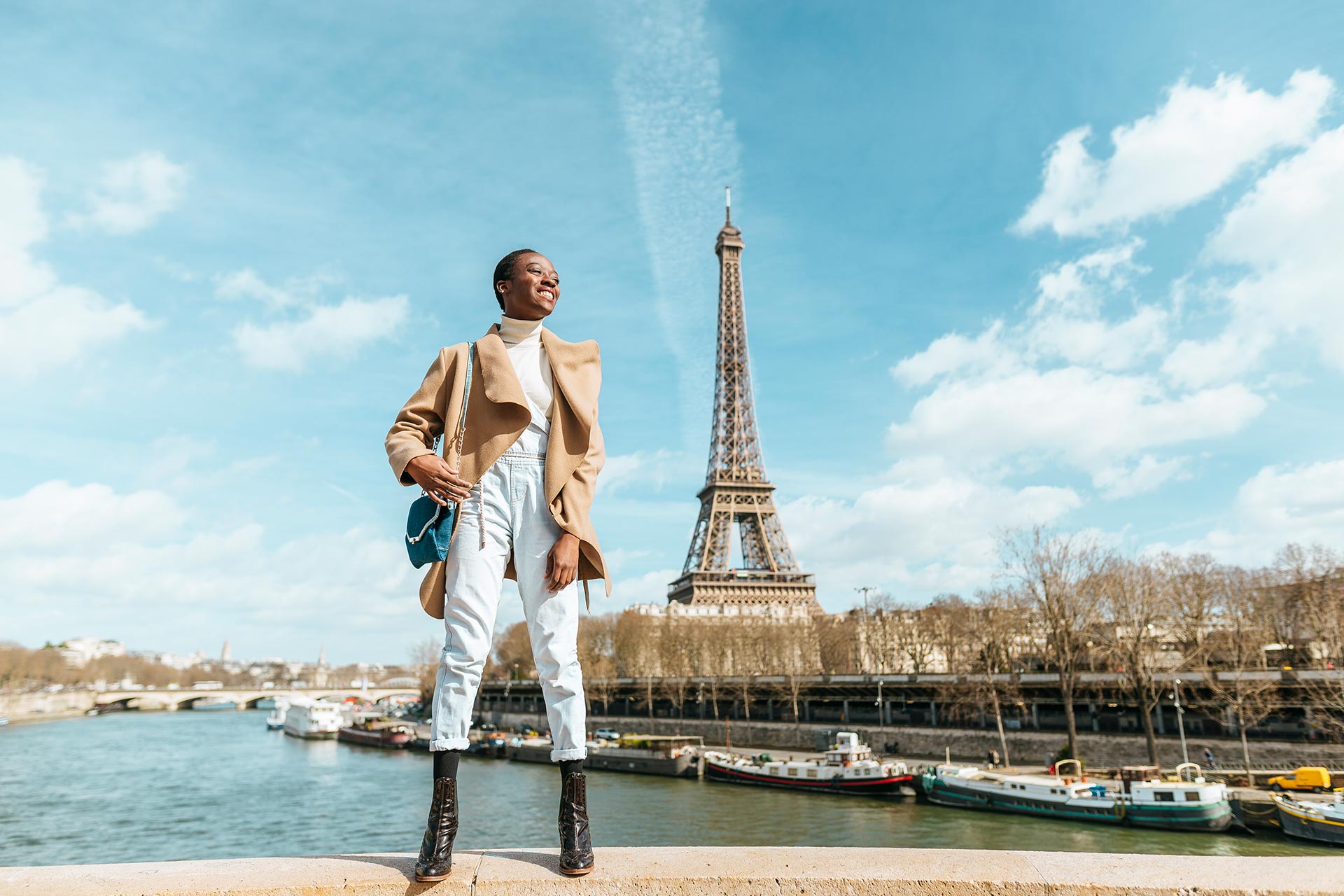 france-paris-smiling-woman-standing-on-a-bridge-2022-12-16-22-28-50-utc.jpg